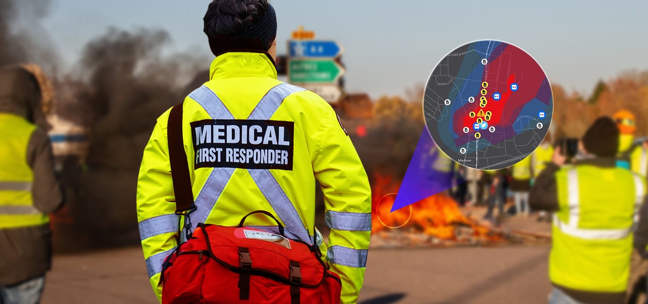 A medical first responder with medical supplies standing near a fire